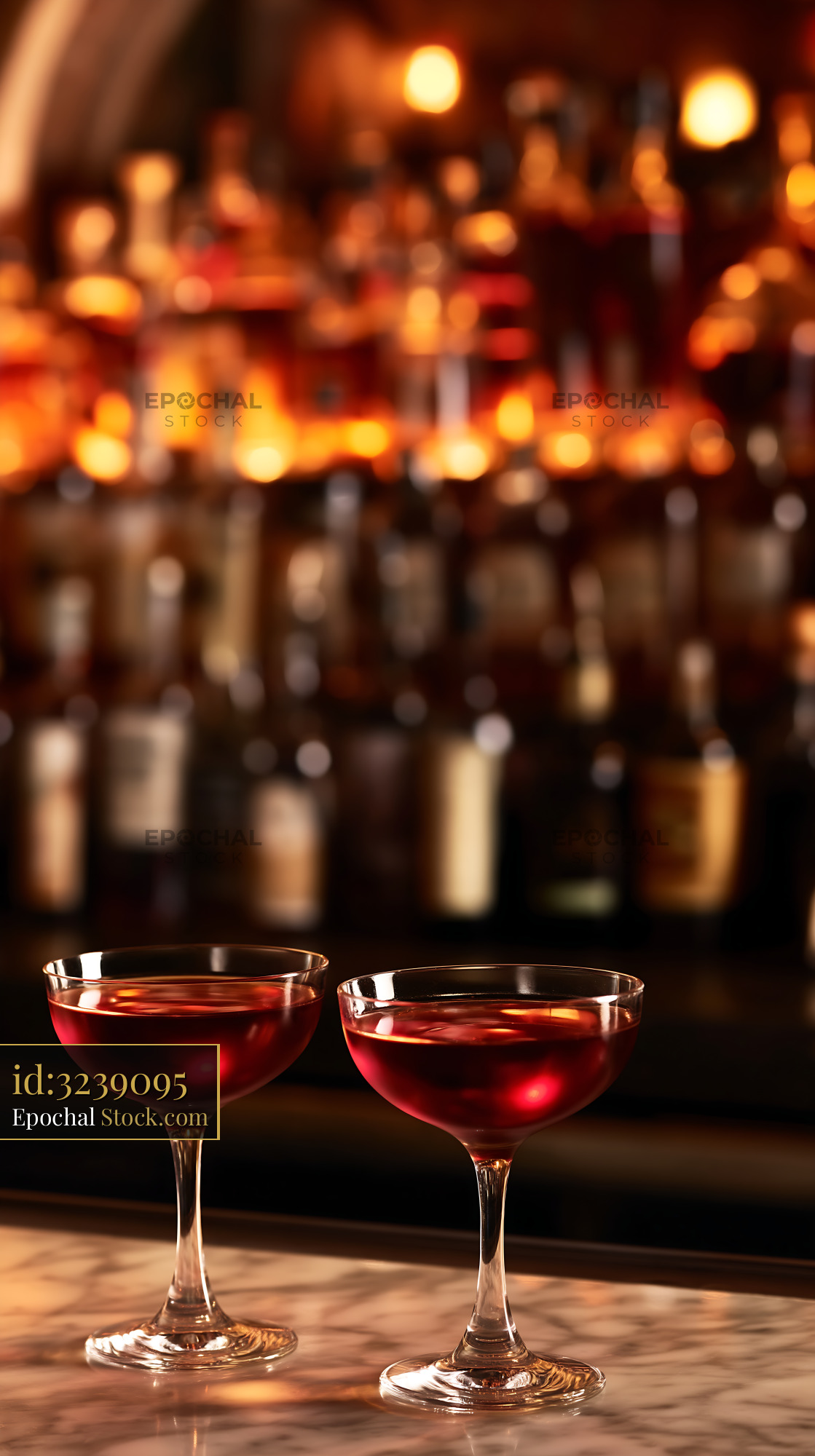 Two Red Cocktails on Marble Bar with Blurred Background - stock photo