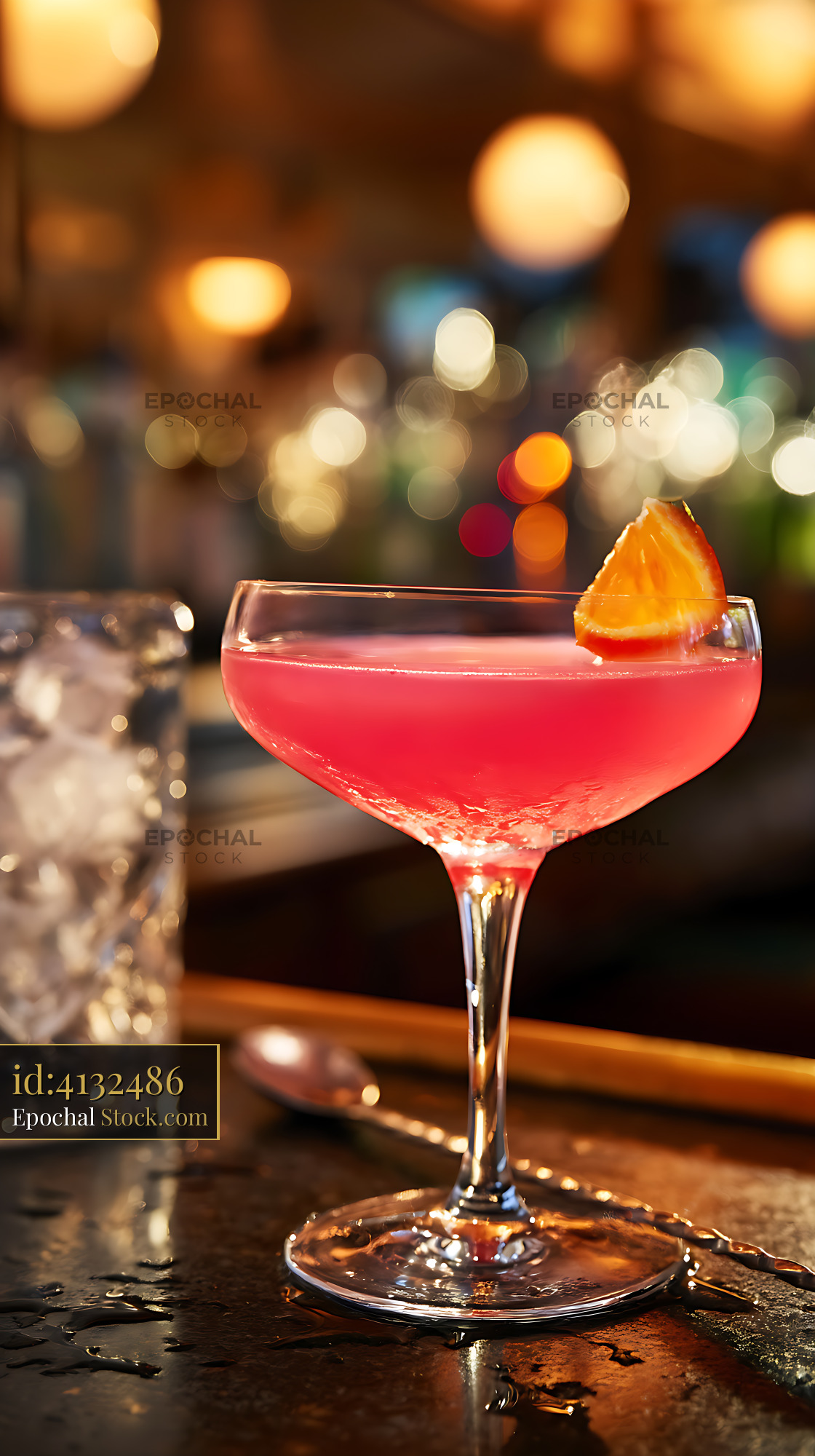 Pink Cocktail with Orange Garnish at Bar - stock photo