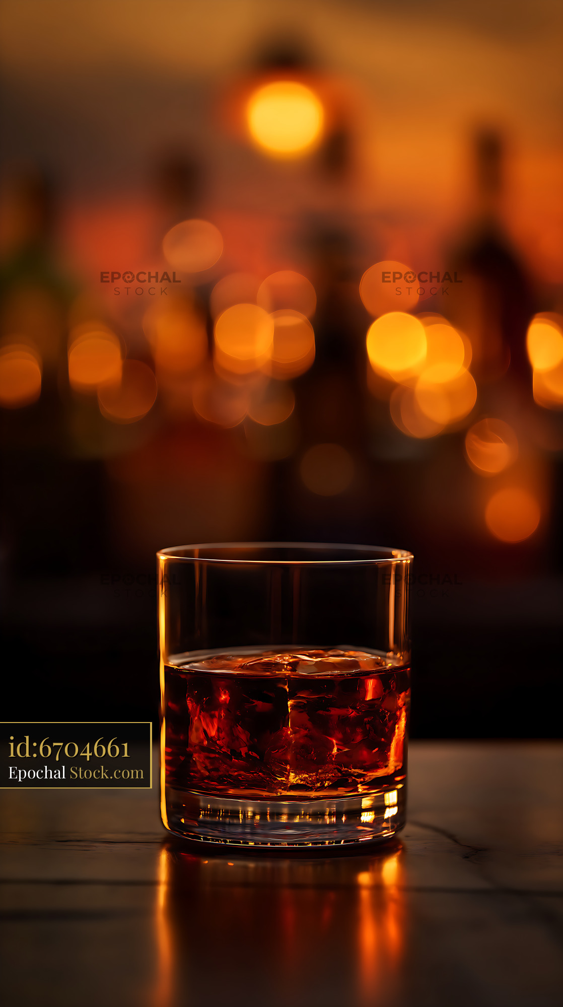Amber Whiskey Glass with Ice Under Evening Lights - stock photo