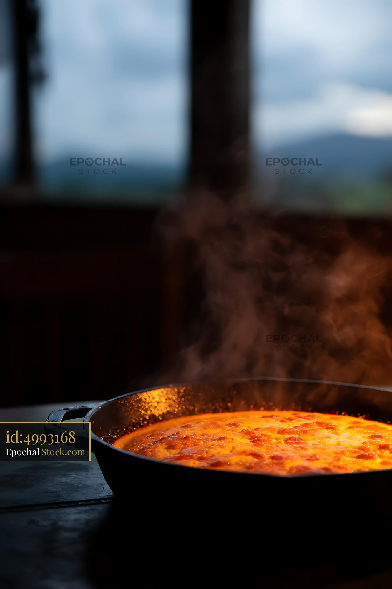 Steaming Cast Iron Skillet With Mountain View - stock photo